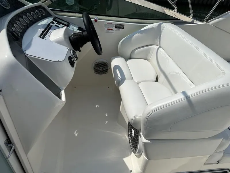 Slide: The Image of 2000 Wellcraft 45 Excalibur cockpit with white leather seating and steering wheel. - 9