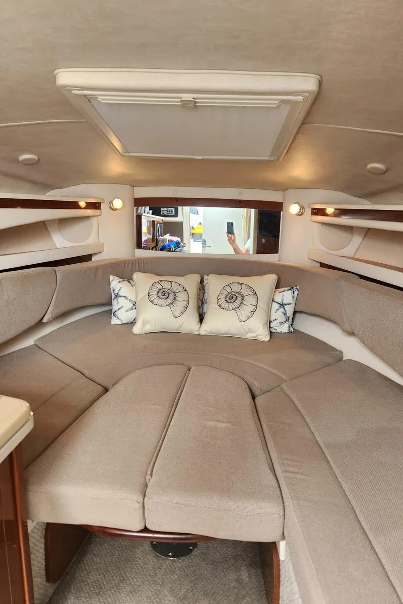 Slide: The Image of Interior of 2008 Sea Ray 260 Sundancer with beige seating and decorative pillows. - 11