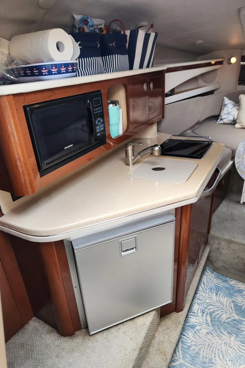 Slide: The Image of Interior of 2008 Sea Ray 260 Sundancer with kitchenette, microwave, and sink. - 14