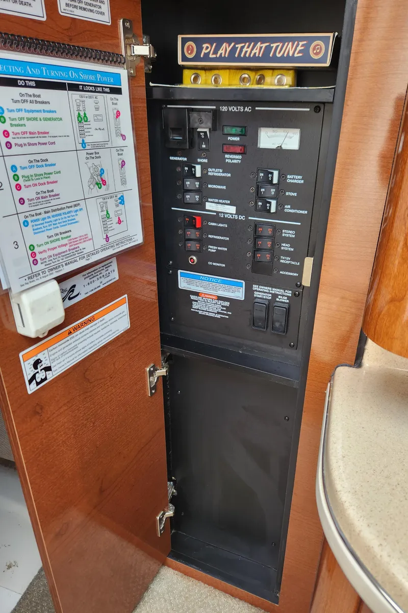Slide: The Image of 2008 Sea Ray 260 Sundancer control panel with "Play That Tune" sign. - 15