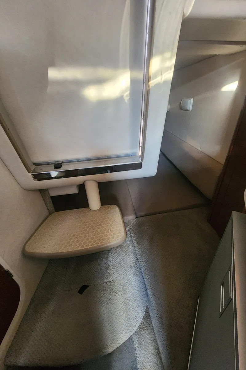 Slide: The Image of Interior cabin of 2008 Sea Ray 260 Sundancer boat, featuring compact seating and storage. - 17