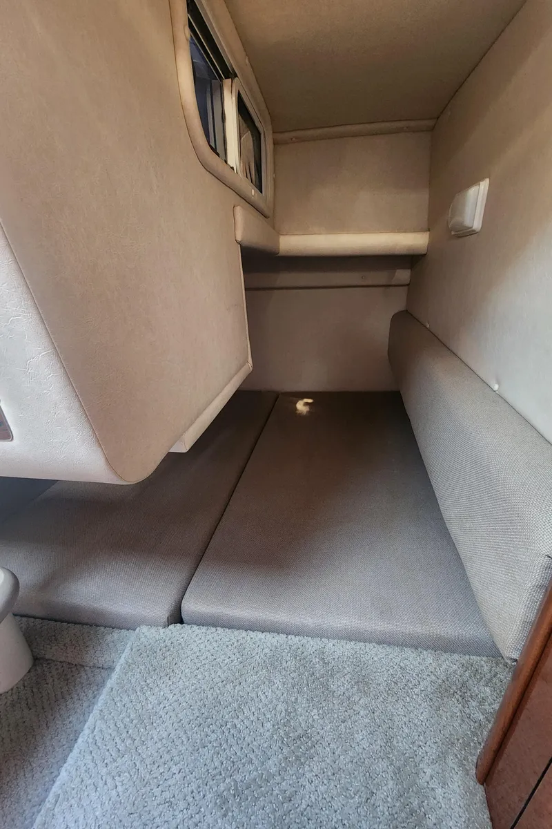 Slide: The Image of 2008 Sea Ray 260 Sundancer cabin interior with cushioned seating and window. - 18