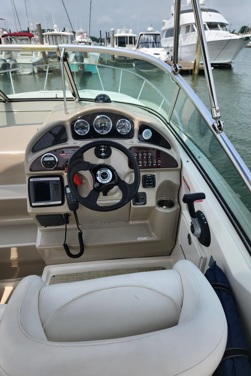 Slide: The Image of 2008 Sea Ray 260 Sundancer boat cockpit with steering wheel and control panel. - 20