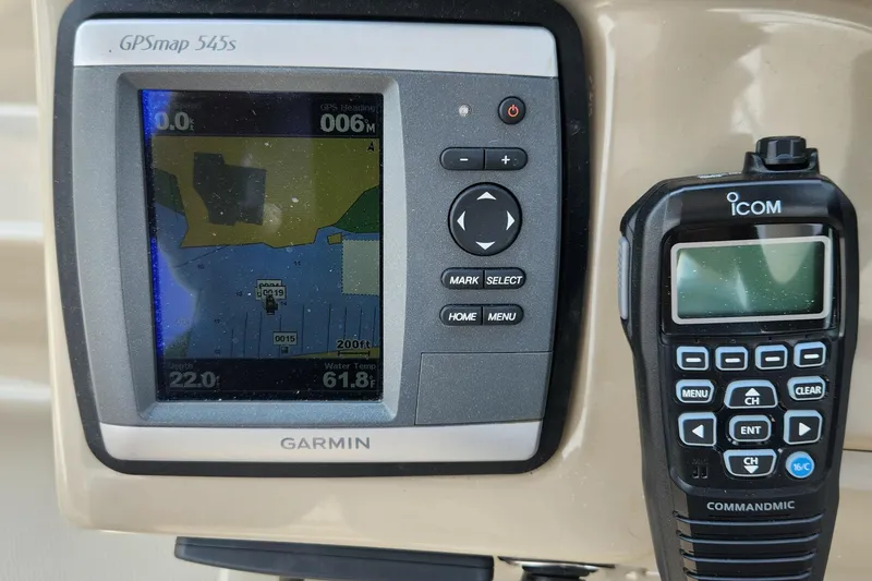 Slide: The Image of Garmin GPS and Icom radio on 2008 Sea Ray 260 Sundancer dashboard. - 21