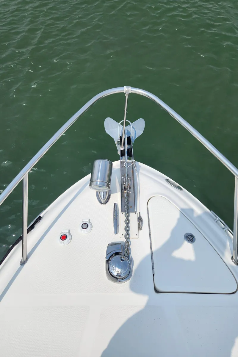 Slide: The Image of 2008 Sea Ray 260 Sundancer bow with anchor, on calm water. - 24