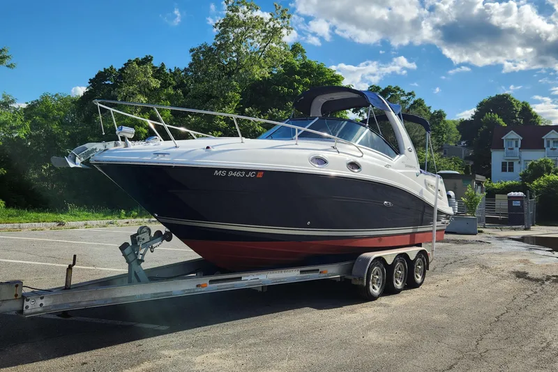 Slide: The Image of 2008 Sea Ray 260 Sundancer boat on trailer in sunny parking lot. - 3