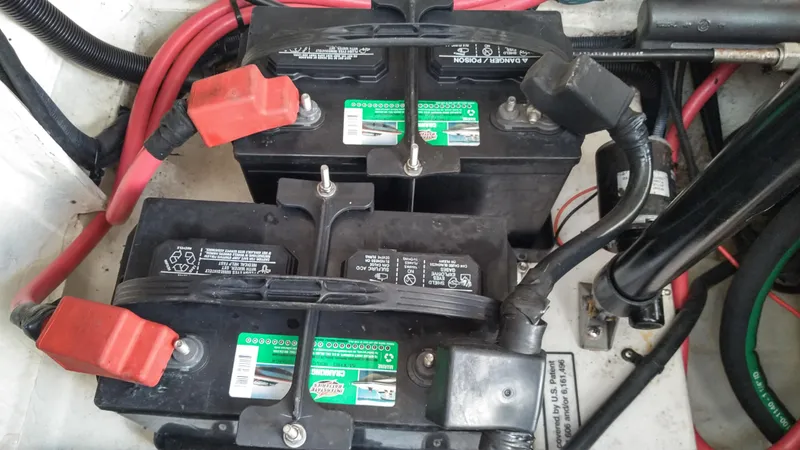 Slide: The Image of Batteries in a 2008 Sea Ray 260 Sundancer boat with red and black cables. - 34