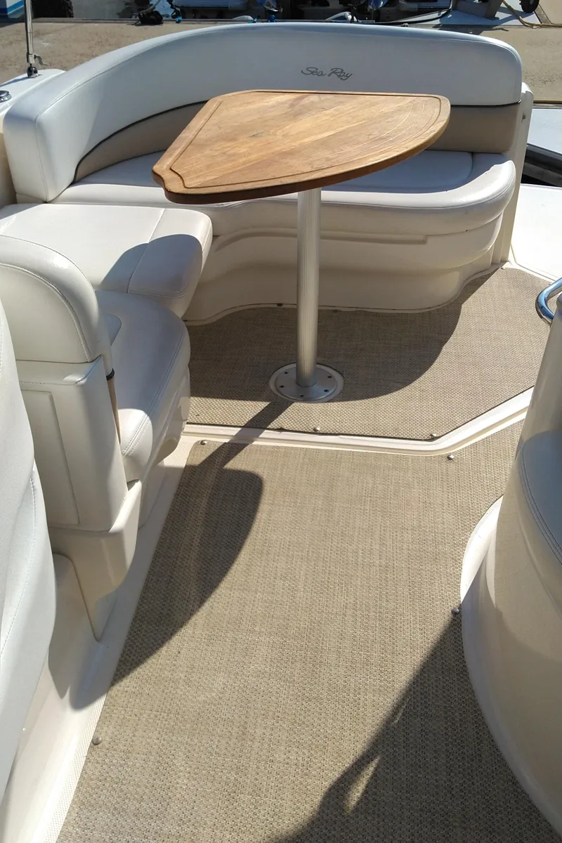 Slide: The Image of 2008 Sea Ray 260 Sundancer interior with seating and wooden table. - 8