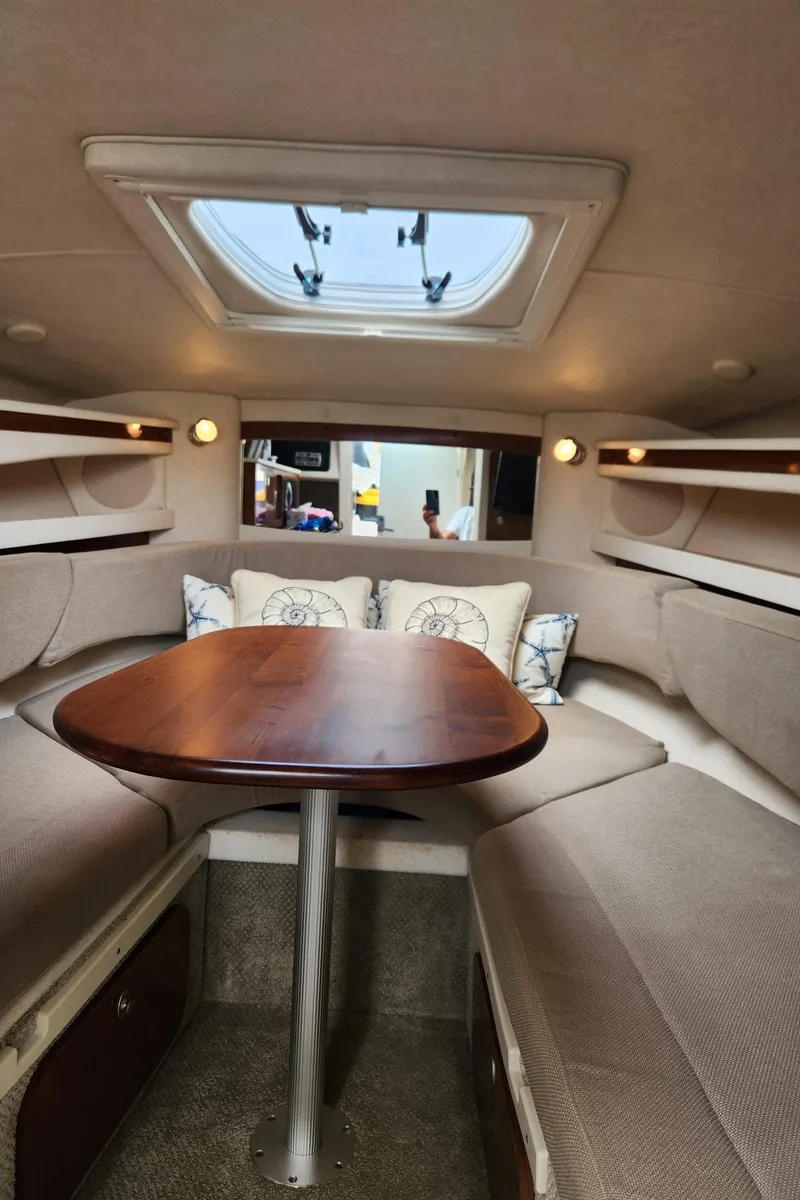Slide: The Image of 2008 Sea Ray 260 Sundancer cabin interior with skylight and seating area. - 9
