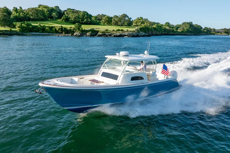 Slide: The Image of 2024 Hinckley Sport Boat 40c cruising on a scenic waterway. - 6