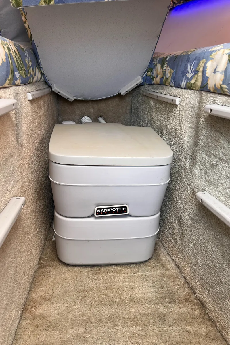 Slide: The Image of 1995 Powerquest 290 Enticer FX cabin with portable toilet. - 10