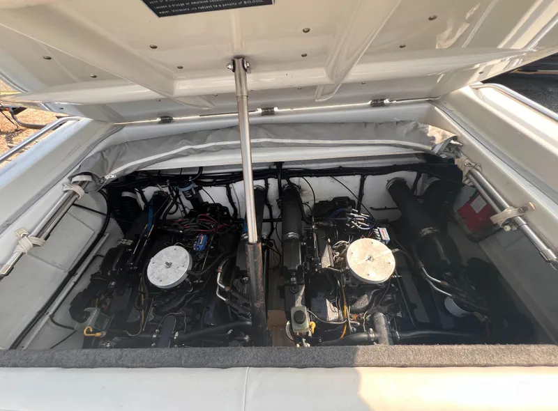 Slide: The Image of 1995 Powerquest 290 Enticer FX boat engine compartment with dual engines. - 13