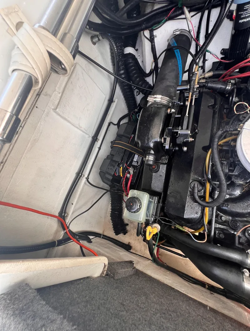 Slide: The Image of Engine compartment of 1995 Powerquest 290 Enticer FX boat, showing wiring and components. - 19