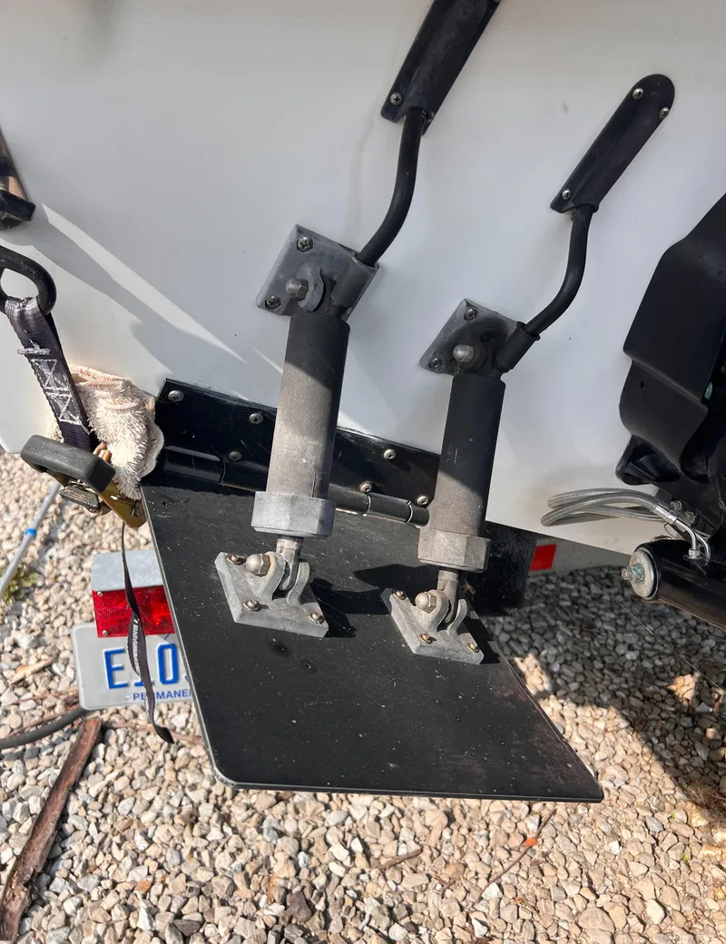 Slide: The Image of 1995 Powerquest 290 Enticer FX boat trim tabs and license plate detail. - 21