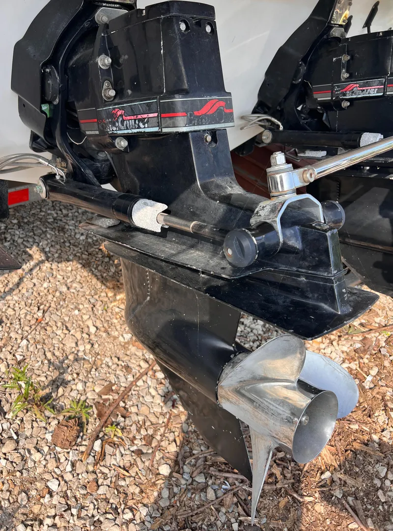 Slide: The Image of 1995 Powerquest 290 Enticer FX boat engine and propeller on gravel surface. - 22