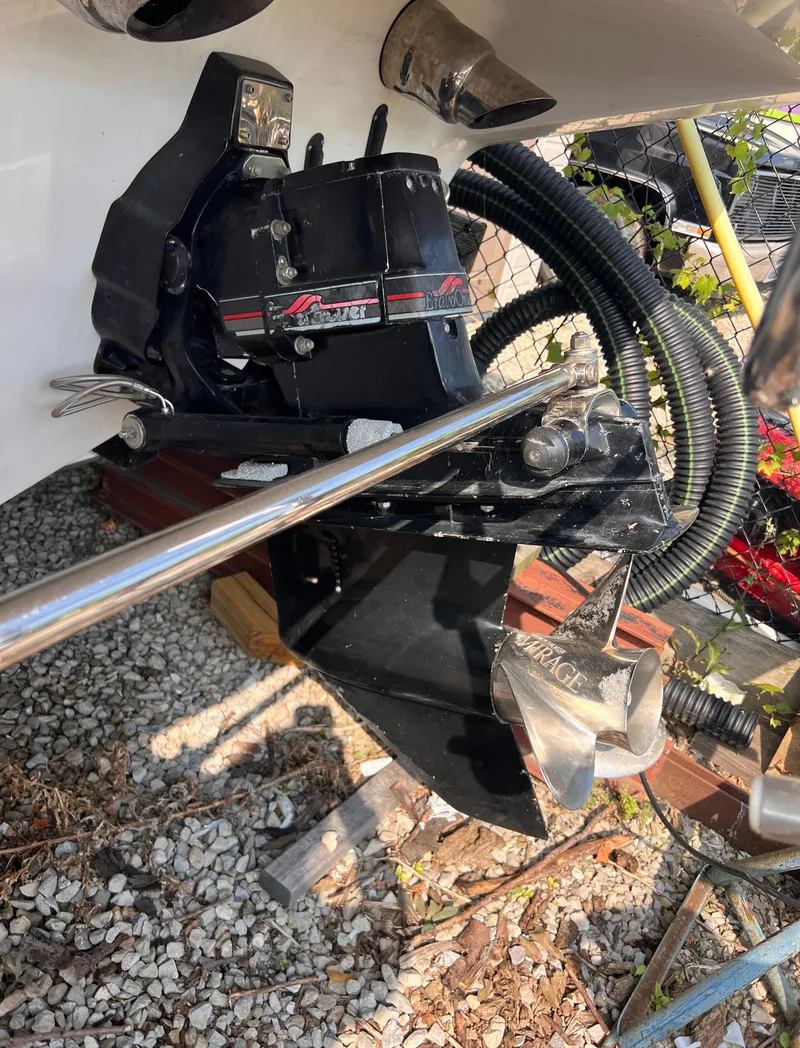 Slide: The Image of 1995 Powerquest 290 Enticer FX boat engine and propeller detail on gravel surface. - 26