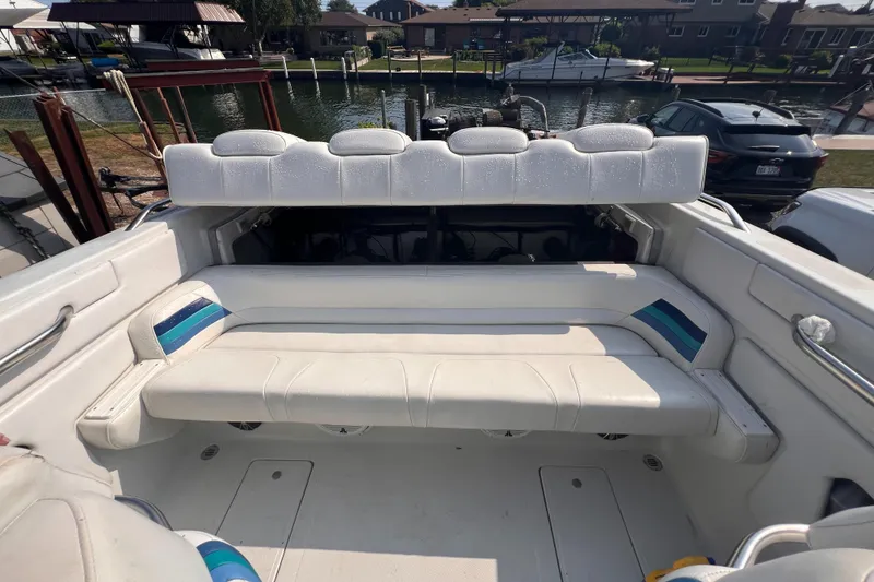 Slide: The Image of 1995 Powerquest 290 Enticer FX boat interior with white seating and waterfront view. - 5