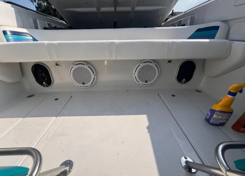 Slide: The Image of 1995 Powerquest 290 Enticer FX boat interior with speakers and cleaning supplies. - 6