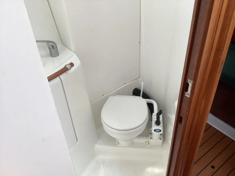 Slide: The Image of Beneteau 393 2002 yacht bathroom with compact toilet and sink. - 17