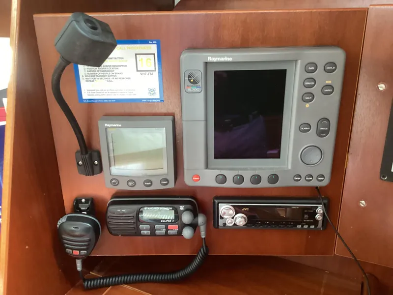 Slide: The Image of Beneteau 393 2002 navigation panel with Raymarine electronics and communication devices. - 19