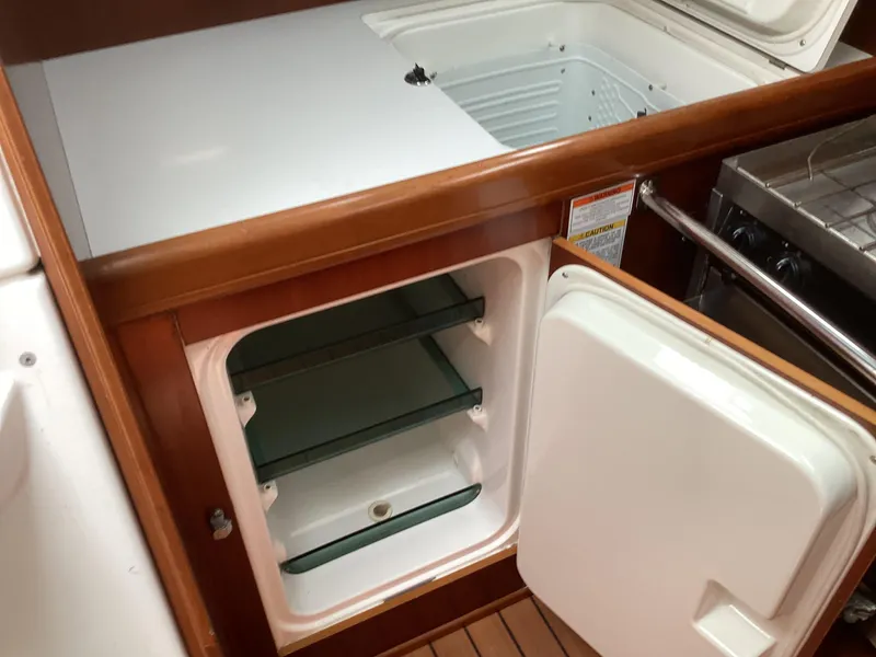 Slide: The Image of Beneteau 393 yacht kitchen with open fridge and freezer, 2002 model. - 2