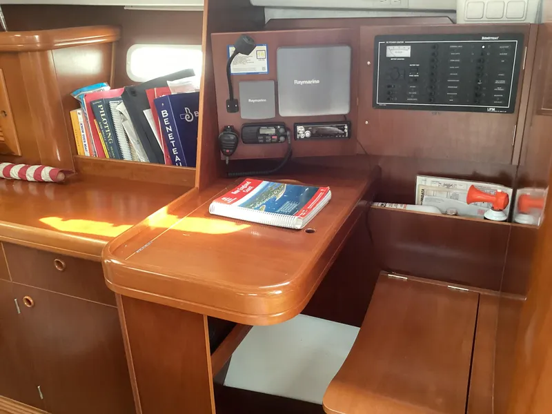 Slide: The Image of Beneteau 393 sailboat interior with navigation station and books, 2002 model. - 22