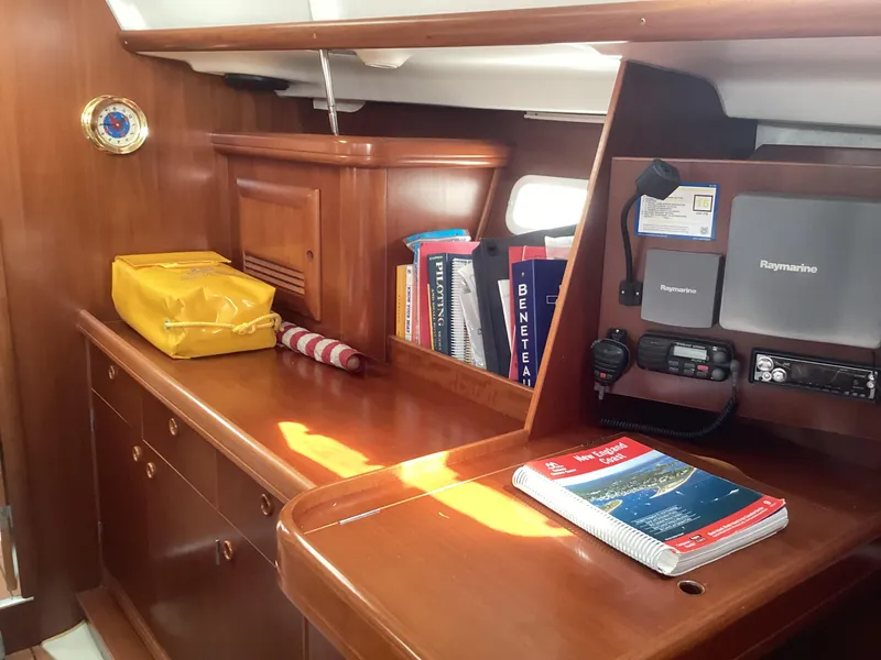 Slide: The Image of Interior of 2002 Beneteau 393 sailboat with navigation equipment and wooden cabinetry. - 23