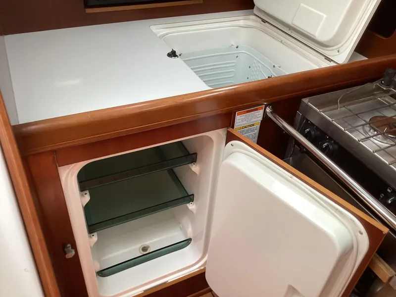 Slide: The Image of Beneteau 393 yacht kitchen with open fridge and freezer, 2002 model. - 3
