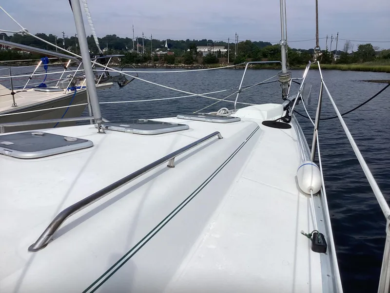 Slide: The Image of 2002 Beneteau 393 sailboat deck view on calm water. - 32