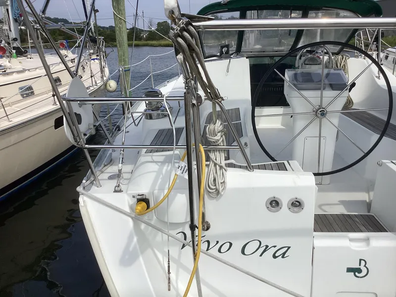 Slide: The Image of 2002 Beneteau 393 sailboat with steering wheel and deck view. - 34