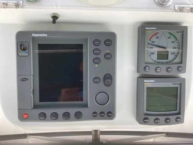 Slide: The Image of Raymarine navigation instruments on a 2002 Beneteau 393 sailboat dashboard. - 36