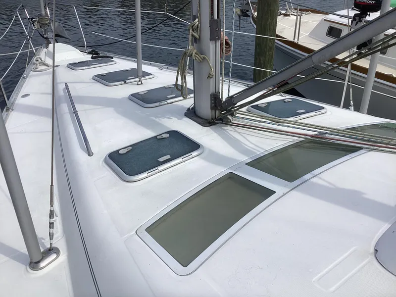 Slide: The Image of Deck of 2002 Beneteau 393 sailboat with hatches and rigging. - 40