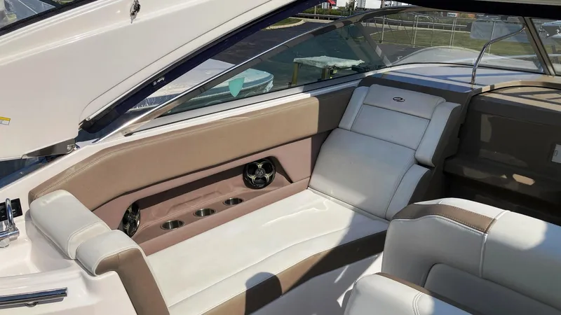 Slide: The Image of Interior of 2016 Regal 28 Express boat with beige and white seating. - 10