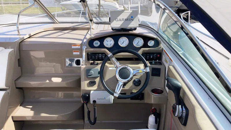 Slide: The Image of 2016 Regal 28 Express boat cockpit with Garmin navigation system and steering wheel. - 11