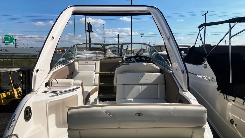 Slide: The Image of 2016 Regal 28 Express boat interior with seating and dashboard, docked outdoors. - 4