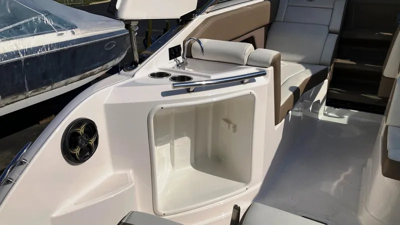 Slide: The Image of 2016 Regal 28 Express boat interior with seating and storage compartment. - 7