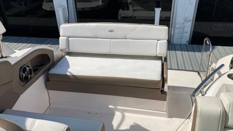 Slide: The Image of 2016 Regal 28 Express boat interior with white seating and steering wheel. - 9
