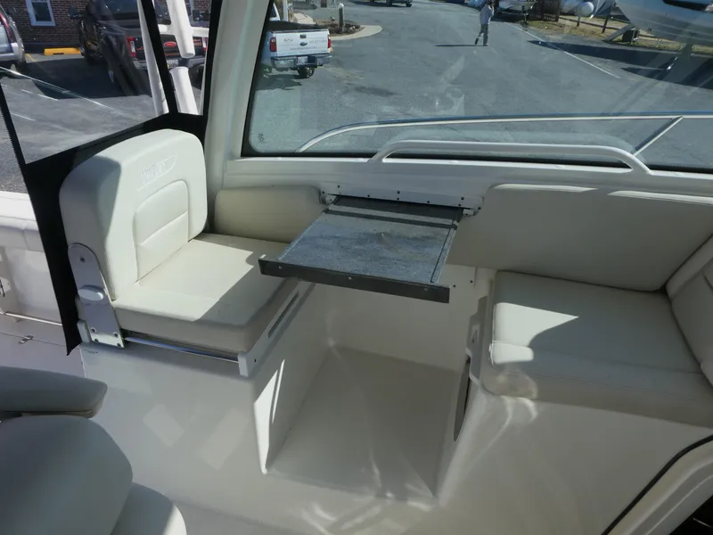 Slide: The Image of 2024 Boston Whaler 285 Conquest interior seating with foldable table. - 10