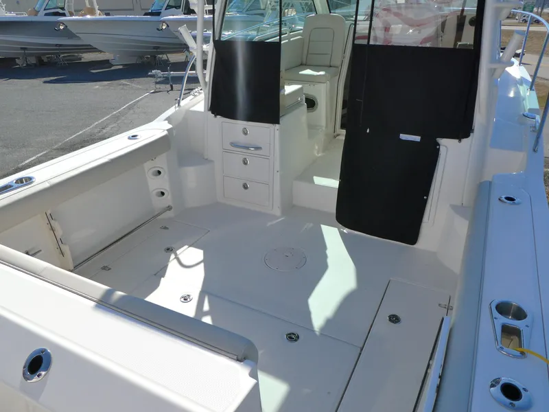 Slide: The Image of 2024 Boston Whaler 285 Conquest boat interior, featuring spacious deck and seating area. - 3