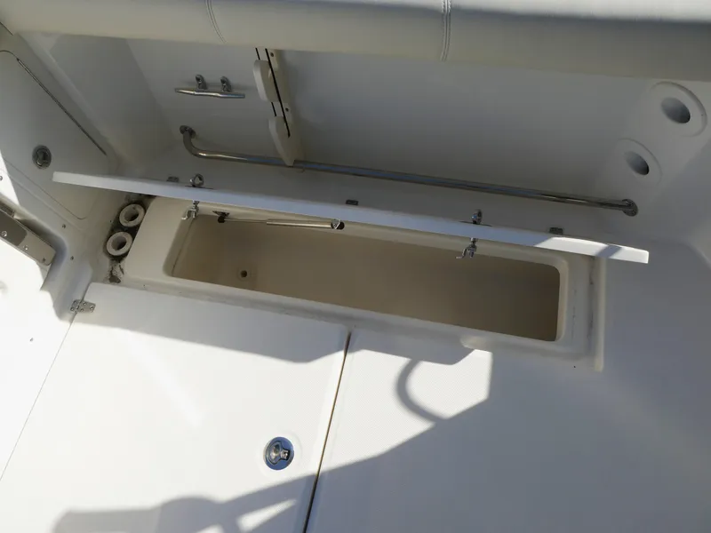 Slide: The Image of 2024 Boston Whaler 285 Conquest storage compartment, open and empty, showcasing interior space. - 6