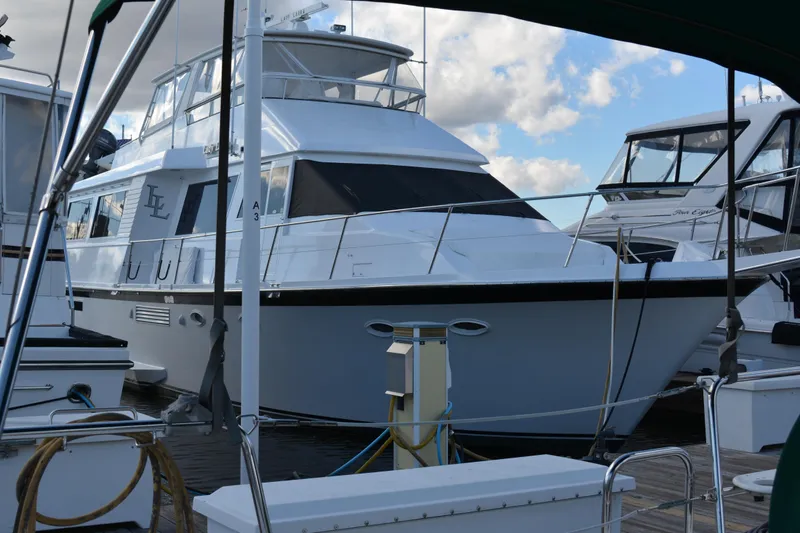 Slide: The Image of 1989 Viking Motor Yacht docked at marina under blue sky. - 0