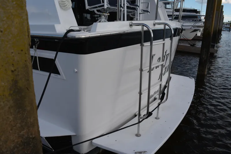 Slide: The Image of 1989 Viking Motor Yacht docked with swim platform and ladder. - 13