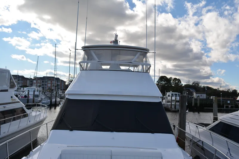 Slide: The Image of 1989 Viking Motor Yacht docked under a partly cloudy sky. - 16