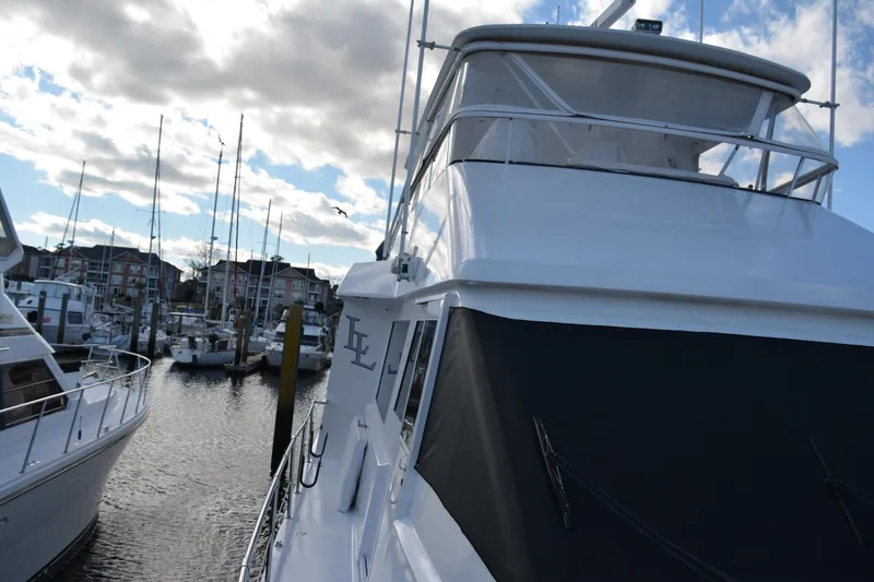 Slide: The Image of 1989 Viking Motor Yacht docked in a marina under a cloudy sky. - 17