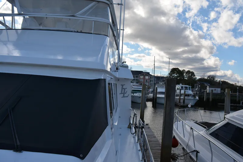 Slide: The Image of 1989 Viking Motor Yacht docked at marina under partly cloudy sky. - 18