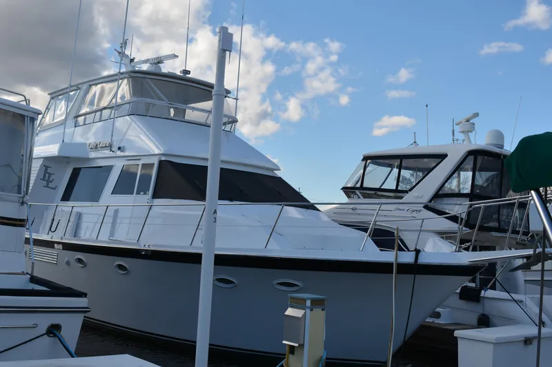 Slide: The Image of 1989 Viking Motor Yacht docked at marina under blue sky. - 2