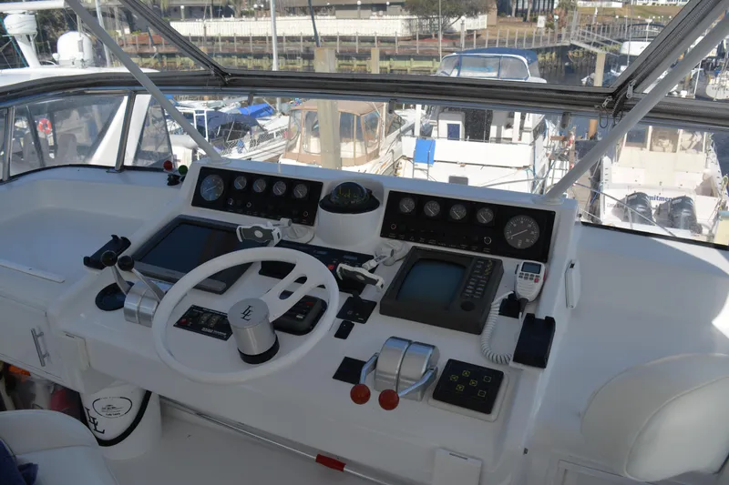 Slide: The Image of 1989 Viking Motor Yacht helm with navigation instruments and steering wheel. - 21