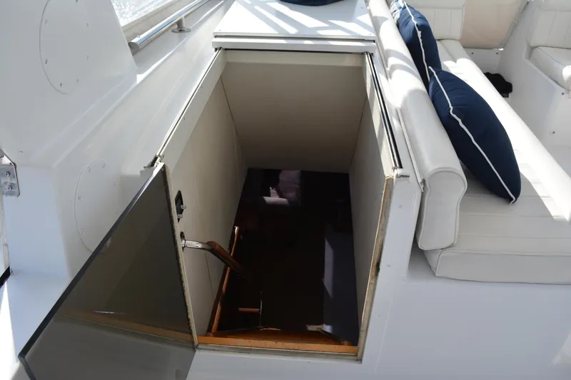 Slide: The Image of Stairway entrance on 1989 Viking Motor Yacht, next to white seating with blue cushions. - 27