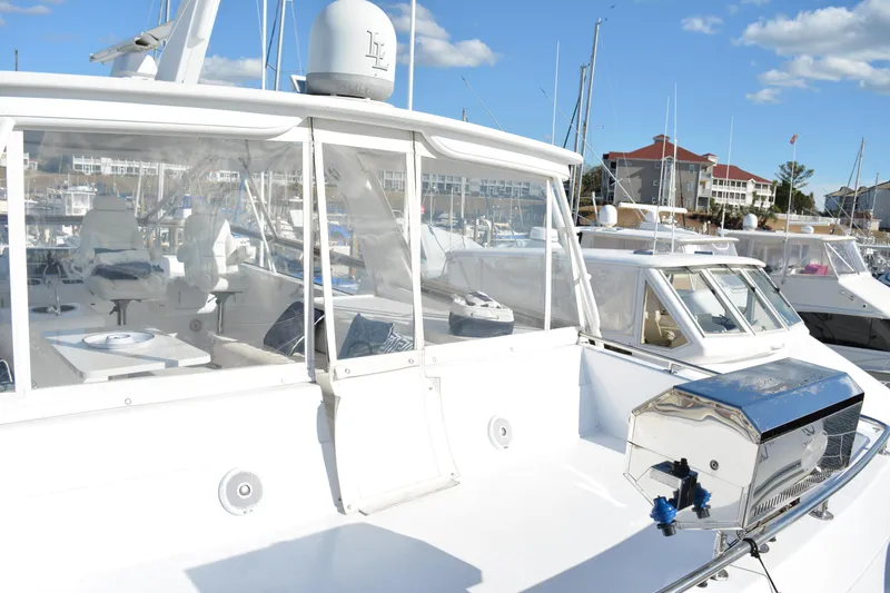 Slide: The Image of 1989 Viking Motor Yacht docked at marina under clear blue sky. - 28