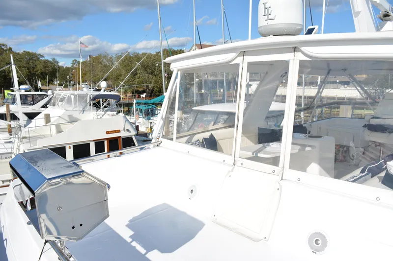 Slide: The Image of 1989 Viking Motor Yacht docked at marina under blue sky. - 29